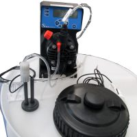 Detailed view on reagent buffer tank with pH metering pump for neutralization control.