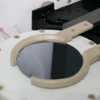 Detailed view on electrical gripper used for wafer transfer inside process tanks.