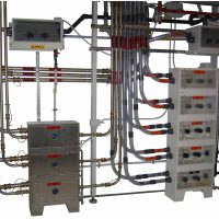 example of installation of acid vs solvent piping lines: external transparent PVC for safety containment (acids), SS304 (solvents); internal ultra pure PFA material.